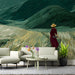 Home office interior with a serene grassy hill mural and wood accents