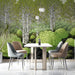 A dining room interior showcasing a nature-inspired forest mural in vibrant green and deep charcoal.