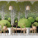 A bright bar wall featuring a modern birch tree mural with green and black accents.