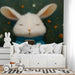 Playful rabbit scene mural used as a focal wall in a quiet bedroom