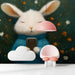 Whimsical rabbit mural installed on the wall of a cozy modern nursery