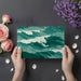 Serene home office space featuring a large scale ocean wave mural on the main wall