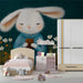 Artistic forest animal mural in a childs bedroom with warm accent lighting