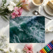 Large-scale ocean wave wallpaper installed in a modern home office
