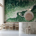 Modern bar featuring a large-scale ocean wave mural behind a minimalist gray sofa