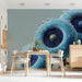 Modern dining room featuring a vibrant blue floral mural behind a minimalist beige sofa