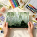 An office space featuring a forest nature wallpaper to provide a calming, natural backdrop for productivity.