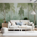 A cozy living room with a tranquil birch forest mural covering the wall behind a neutral linen bed frame.
