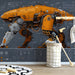 Modern home office with industrial mecha wallpaper on a feature wall behind a wooden desk