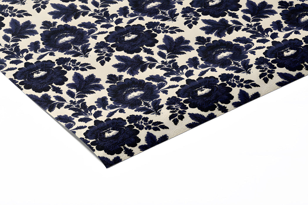 A cozy library with dark navy and cream floral wallpaper