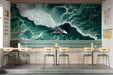 A contemporary cafe featuring a dynamic ocean wave mural as a bold, moody focal point behind a minimalist gray sofa.