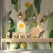 Shop interior with a light and airy botanical mural that inspires productivity.