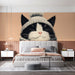 A bedroom wall with a cat illustration mural for a touch of whimsy