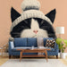 A cozy living room decorated with a charming cat mural wallpaper