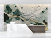 Modern reception featuring an abstract forest green and gold ink wash mural behind a minimalist velvet sofa.