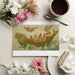 A cozy home library or study space with the mythical fish boat wallpaper behind open shelving.