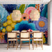 Dining room interior featuring a bold floral wall mural behind a dark wooden table