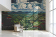 Landscape wall mural installed behind a modern sofa in a study.