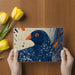 Home office interior featuring a striking avian graphic mural on the back wall