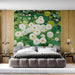 Cozy bedroom interior with a lush green and white floral mural wallpaper feature wall