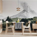 A sophisticated dining room featuring a detailed mountain landscape wall mural behind a dark wood desk.