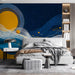 Bedroom with a stylized night sky wallpaper design and soft ambient accent lighting.