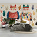 A cozy bedroom featuring a wall mural with stylized cat characters and autumn leaves