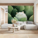 A bright living room wall adorned with a lush green leaf and white cat mural for a tranquil vibe.