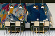 Modern restaurant featuring a statement elephant wall mural behind a neutral cream sofa
