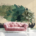 Floating forest wallpaper installed in a modern living room behind a low profile charcoal sofa