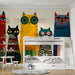 A creative kid's bedroom decorated with a fun cat illustration wallpaper.