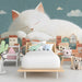 Whimsical cat wall mural featured in a bedroom with a plush armchair and floor lamp