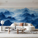 A spacious master living room with a serene blue mountain landscape wall mural behind a modern bed