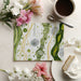 Minimalist home office with a green and ochre cellular pattern wallpaper