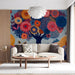 A vibrant botanical wall mural installed in a brightly lit modern living room with minimalist white furniture.