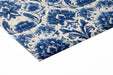 Blue and white damask wallpaper installed in a sophisticated powder room