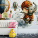 Kids bedroom wall featuring a floating elephant mural with soft blue and orange accents