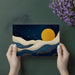 Stylish home office interior with a golden moon and navy blue wave patterned feature wall