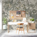 Minimalist study interior with a delicate charcoal and gold foliage mural behind a wooden headboard