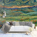 Living room with impressionist countryside mural behind a velvet sofa