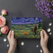 A whimsical bedroom wall featuring a starry night inspired landscape mural with soft ambient lighting.