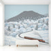 A serene entryway retreat featuring a peaceful snow-covered railway landscape mural.