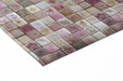 Modern kitchen design with a warm, textured mosaic tile look on the feature wall near a dining table