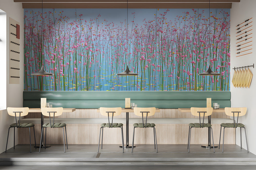 A bright bar wall featuring pink floral wallpaper, light wooden furniture, and white bedding.