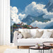 Living room interior featuring an alpine village landscape mural as a panoramic accent wall