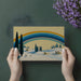 Whimsical art mural depicting a summer hillside in a bright and airy guest bedroom