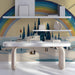 Whimsical winter landscape mural installed in a cozy  study with light wood furniture