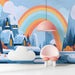 A creative playroom space featuring a vibrant, stylized mountain mural that adds color and imagination.