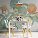 Sunny dining room decorated with an abstract green and orange fruit mural