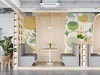 Modern restaurant wall featuring botanical sketch mural with ochre accents